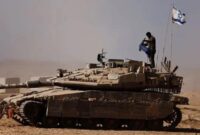 1763248740138-tentara-israel-berdiri-di-atas-tank-militer-yang-disiagakan-di-perbatasan-gaza-1755770598074_169